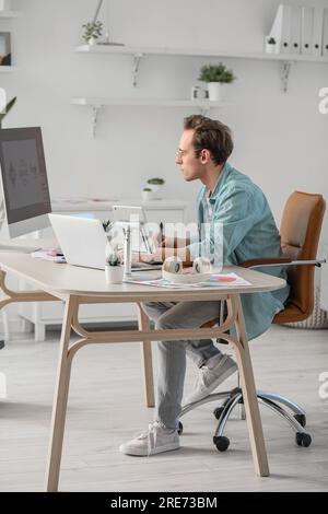 Male graphic designer developing logotype in office Stock Photo
