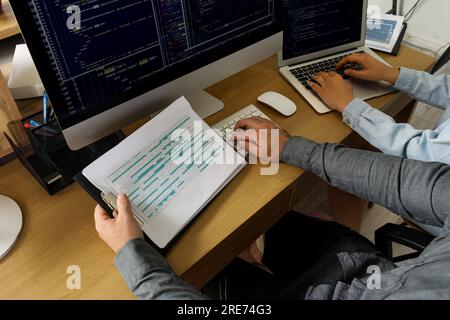 Male programmers working at table in office, closeup Stock Photo