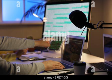 Programmers working in office at night, closeup Stock Photo
