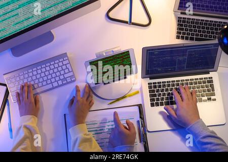 Programmers working in office at night, top view Stock Photo