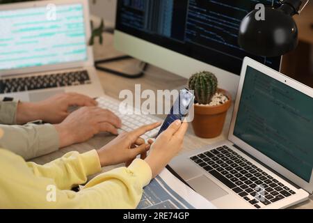 Programmers working at table in office, closeup Stock Photo