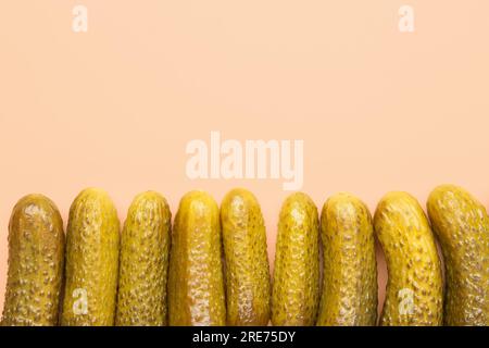 Pickled cucumbers on orange background Stock Photo