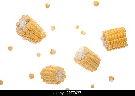 Flying cut corn cobs and kernels on white background Stock Photo