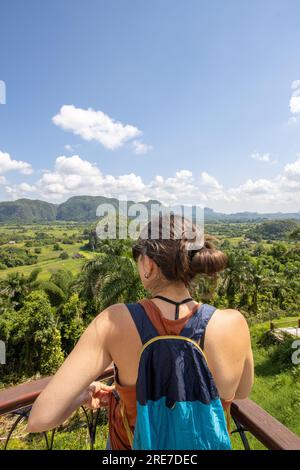 Tourists watching the view from the Vinales Valley viewpoint in Cuba. Tourism in Pinar del Rio in the green valley of Cuban tobacco production. Touris Stock Photo