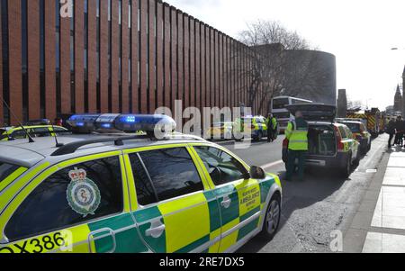 25th February, 2014. Time is about 10.50 am. Emergency service vehicles block Oxford Road, Manchester, University of Manchester area, UK, as fire brigade officers try to free people trapped in two cars after a serious road traffic accident. Police have closed the road with a cordon and it is filled with police, paramedic or ambulance, and fire engine vehicles. Stock Photo