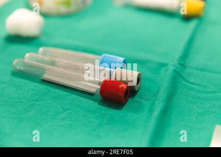 Close up of test tubes on green material at hospital Stock Photo