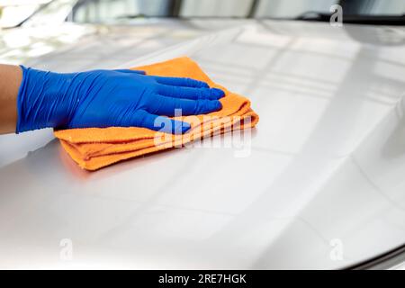 Man polishing car body in the garage Stock Photo