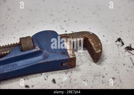 Rusty pipe wrench jaws on the working table. Stock Photo