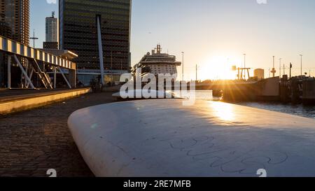 Rotterdam, the Netherlands - 2022-010-18: Beautiful sunset at Rotterdam Wilhelminakade quay with a cruiseship at the cruise terminal Stock Photo