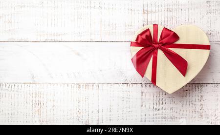 Gift box on white wooden background. Top view with copy-space Stock Photo