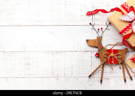 Christmas decoration and gift boxes on white wooden background. Stock Photo