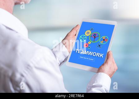 Tablet screen displaying a teamwork concept Stock Photo