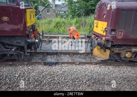 Diesel 'Chris Fudge' linking up to unnamed WCR 37706 diesel loco in WCR 'claret' livery,at the rear of Sierra Leone steam train 25th July 2023. Stock Photo