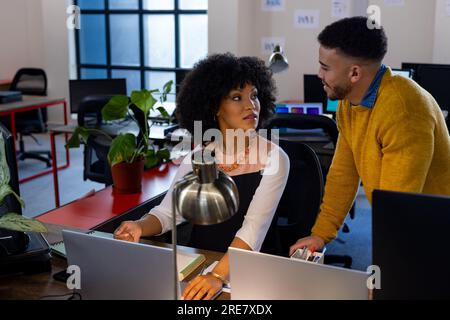 Happy diverse businesspeople talking to each other at office Stock Photo