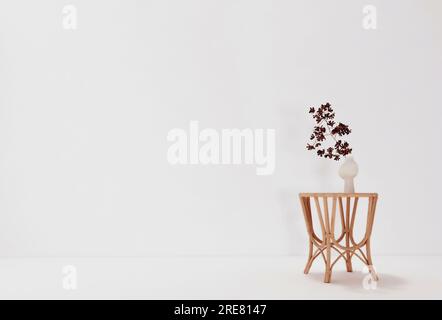Blank white wall and a flower on the table, mockup, 3d render Stock Photo