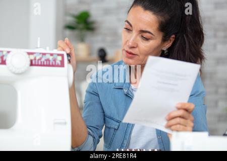 woman using screwdriver repairing sewing-machine Stock Photo
