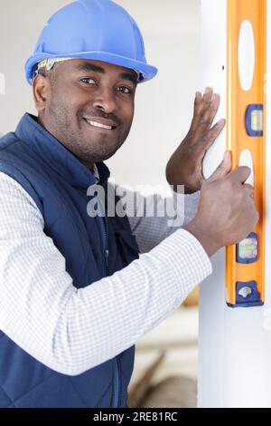male builder using spirit level Stock Photo