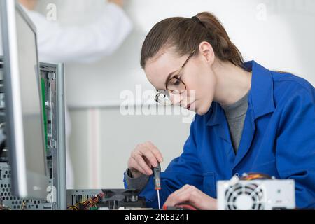 female computer engineer repairing computer motherboard Stock Photo