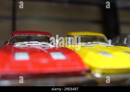 A close up photo of a small painted toy cars on a store shelf. Stock Photo