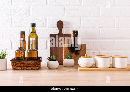 Beautiful kitchen backdrop with storage area for various bottled oils. cutting boards. Indoor flowers in the inside of the kitchen. Compact storage Stock Photo