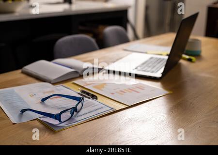 Laptop on wooden table in dining room Stock Photo
