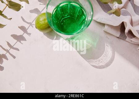 Top view aesthetic lime healthy tarragon detox sparkling cocktail. Non alcoholic vitaminized drink. Green Mocktail for St. Patricks Day. Copy space, Stock Photo