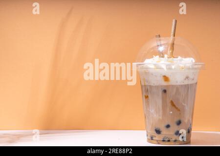 Tapioca boba balls coffee frappe, asian trendy cold coffee drink with tapioca balls and whipped coconut cream and caramel sauce Stock Photo