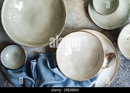 Table setting with ceramic bowls on grey concrete table Stock Photo
