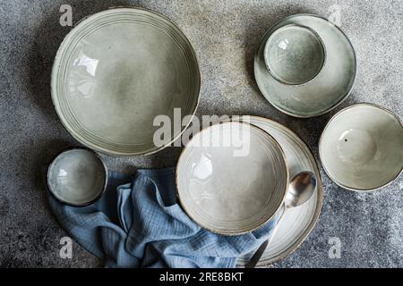 Table setting with ceramic bowls on grey concrete table Stock Photo