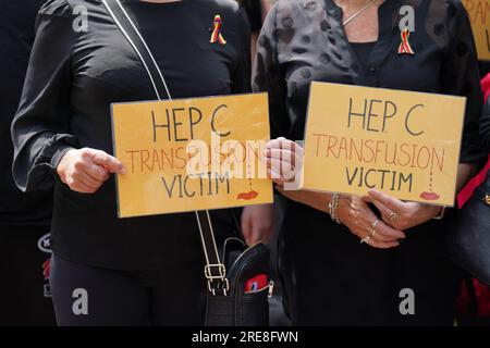 Campaigners, including many who are personally infected and affected by infected blood, hold placards as they gather in Westminster, London, calling for compensation for victims to be authorised by Prime Minister Rishi Sunak, who is giving evidence later to the Infected Blood inquiry. Picture date: Wednesday July 26, 2023. Stock Photo