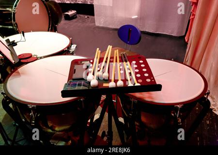 Image of percussion musical instrument timpani with drum sticks on stage Stock Photo