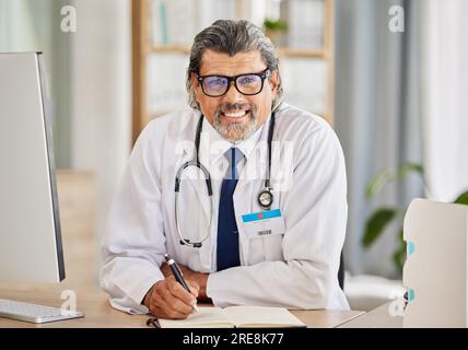 Portrait, man and doctor writing in notebook for healthcare schedule, planning and clinic management in office. Information, ideas and notes of Stock Photo