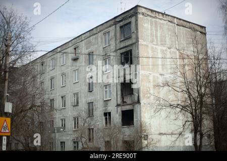 Burnt house. After fire in apartment. Old building in city. Broken windows. Abandoned residential building. Stock Photo