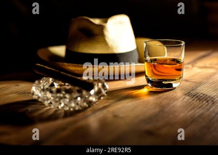 glas of rum, cigar and a panama hat in a bar in Cuba Stock Photo