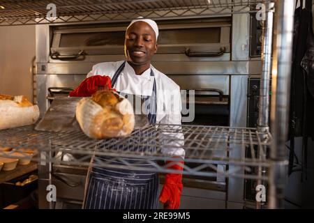 Handsome African American Baker Tray Fresh Loaves Bread Baking Manufacture  Stock Photo by ©ArturVerkhovetskiy 186864520