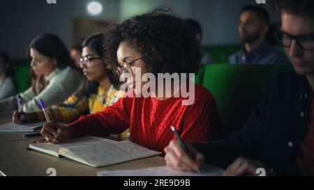 Smart Young Students Studying in University with Diverse Multiethnic Classmates. Scholars Have a Conversation in College Room. Applying Knowledge Stock Photo