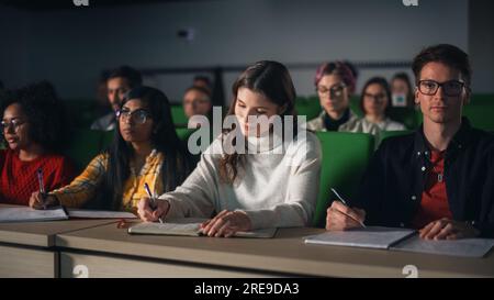 Smart Young Students Studying in University with Diverse Multiethnic Classmates. Scholars Have a Conversation in College Room. Applying Knowledge Stock Photo