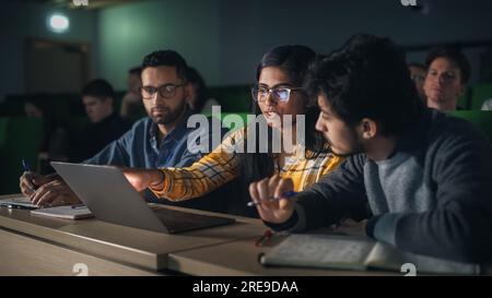 Smart Young Students Studying in University with Diverse Multiethnic Classmates. Scholars Have a Conversation in College Room. Applying Knowledge Stock Photo
