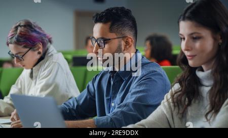 Smart Young Students Studying in University with Diverse Multiethnic Classmates. Scholars Have a Conversation in College Room. Applying Knowledge Stock Photo