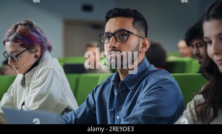 Close Up Portrait of a Creative Student in Lecture. Young Person Studying in University with Diverse Multiethnic Classmates, , Attending Conference Stock Photo