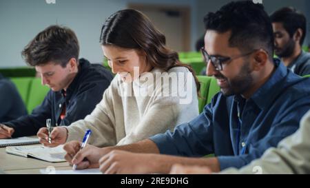 Smart Young Students Studying in University with Diverse Multiethnic Classmates. Scholars Have a Conversation in College Room. Applying Knowledge Stock Photo