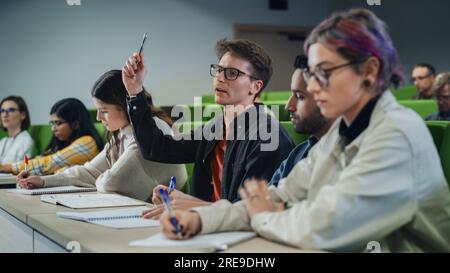 Smart Young Students Studying in University with Diverse Multiethnic Classmates. Scholars Have a Conversation in College Room. Applying Knowledge Stock Photo