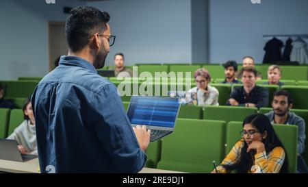 Teacher Giving a Lecture to a Diverse Multiethnic Group of Female and Male Students in Modern College Room. Curious and Thoughtful Scholars Studying Stock Photo