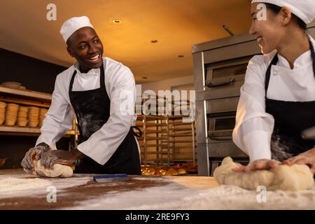 baker weighing bread dough on scale at bakery Stock Photo - Alamy