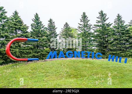 Magnetic Hill is a tourist attraction in Moncton New Brunswick where visitors are subject to an optical illusion that makes them feel that their vehic Stock Photo