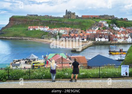 Looking from Whalebone arch in Whitby, North Yorkshire, over the river Esk.  Background shows  the ruins of Whitby Abbey. Whitby, Yorkshire, England Stock Photo