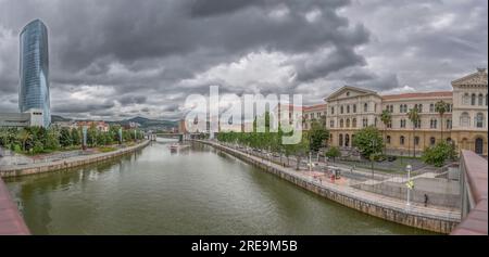 Bilbao Spain - 07 05 2021: Panoramic exterior view at the Bilbao downtown city, Nervion river and river banks and iconic buildings Stock Photo