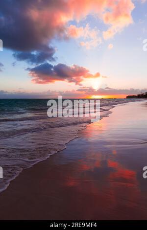 Colorful sunrise with pink clouds in the sky over Atlantic Ocean coast, Bavaro beach, Punta Cana. Dominican Republic Stock Photo