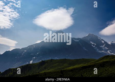 Lenticular clouds above the Eiger North Face and Jungfrau mountain peaks, seen from Mannlichen above Wengen, Bernese Oberland, Switzerland Stock Photo