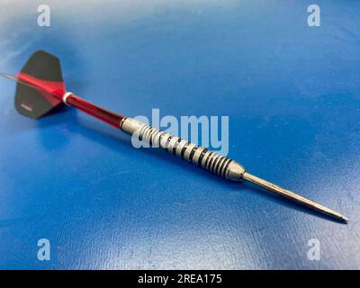 Dart on a blue table Stock Photo